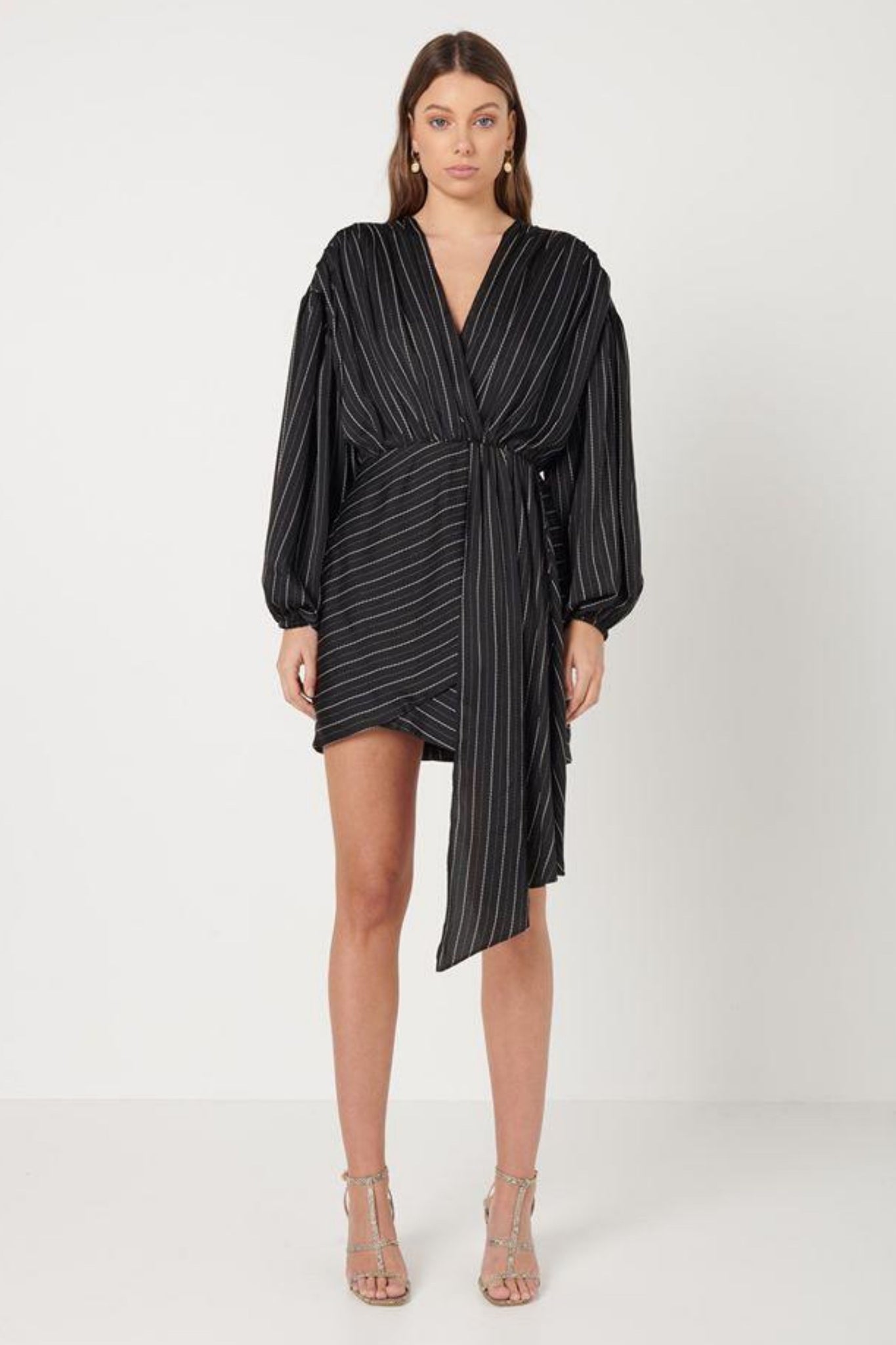 Elliatt Collective Pavilion Mini Dress in black and whilte pinstripe. Long Sleeve Black Mini Dress with Faux wrap skirt and plunge neckline. Long fabric drape dress cocktail race dress and wedding guest outfit.